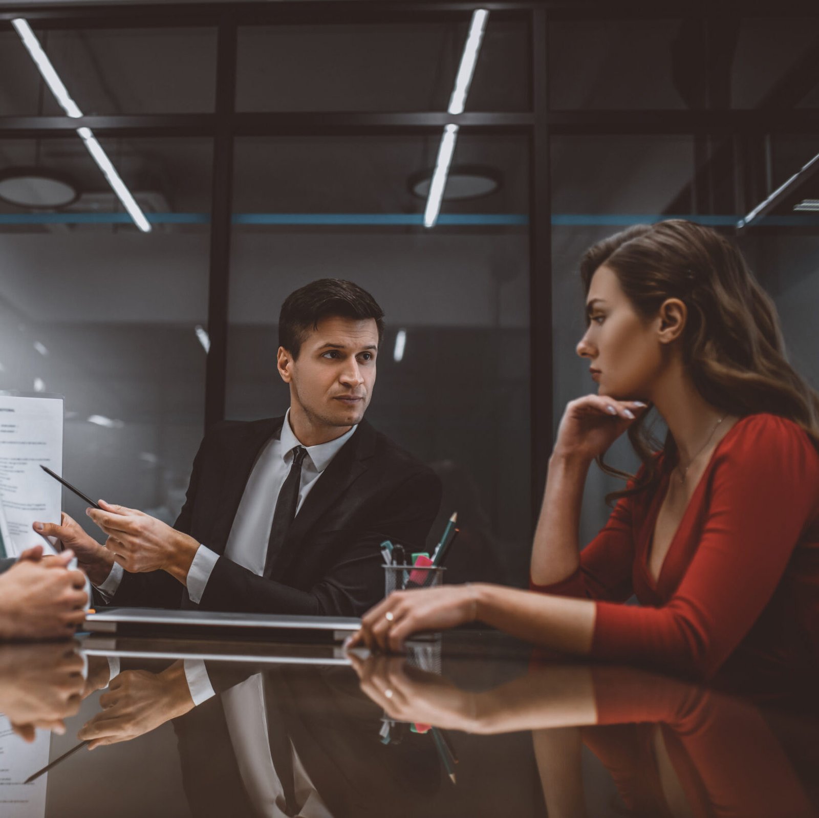 Lawyer pointing at a marital contract to spouses